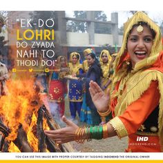 a woman is dancing around a fire with her hands in the air and other people behind her