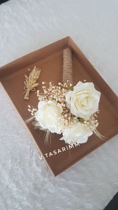 a brown tray with white flowers and leaves on it that says tasarrimm