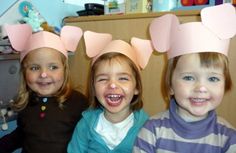 three young children wearing paper crowns on their heads