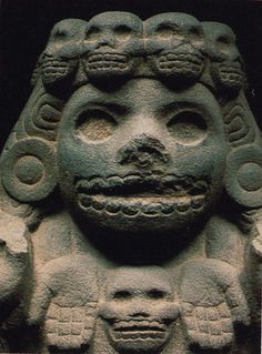 an ancient statue with many faces on it's face and two heads in the center