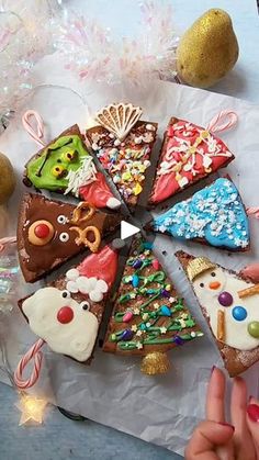 a person holding a piece of cake with different toppings on it next to christmas decorations