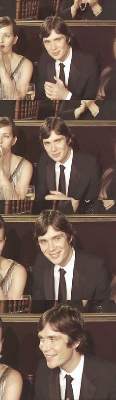 a man in a suit and tie sitting at a table with his hands on his face