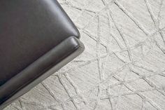 a black suitcase sitting on top of a white carpeted floor next to a chair