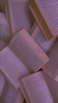 a pile of purple books with sparkles on them