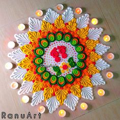 an intricately decorated diya with candles on the floor