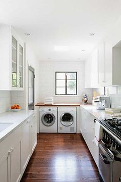 a kitchen with white cabinets and wood flooring next to a stove top oven, dishwasher and washer