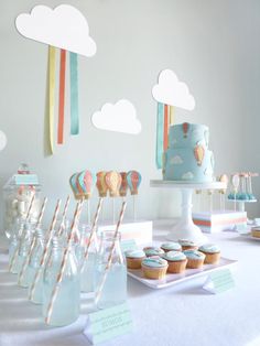 a table topped with lots of cupcakes and candy