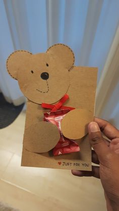 someone holding up a card with a teddy bear on it