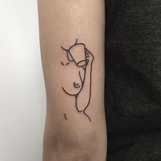 a woman's arm with a black outline drawing of a nude female on it