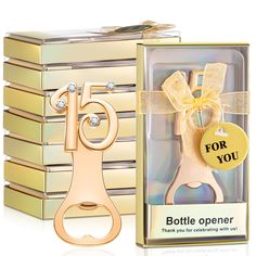 a bottle opener with a bow on it in a gift box