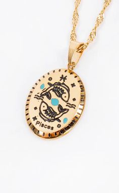 a gold necklace with an image of a dog on the front and back of it