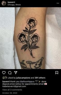 a tattoo with flowers on the arm and an image of two people sitting in front of them