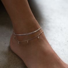 Tiny Crosses dangles from a dainty Sterling Silver chain. Add sparkles to your ankle with this minimal anklet. Sterling Silver Cubic Zirconia crystals, 3mm Hypoallergenic, lead and nickel free Length: 9in (23cm) + Extension: 2in (5cm) Spring clasp closure Handcrafted in NYC #ANK087 Minimal Anklet, Cross Anklet, Cute Anklets, Tiny Cross, Sterling Silver Anklet, Silver Anklets, Chain Anklet, Cuban Link Chain, Cuban Link