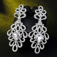 Elegant botanical drop earrings featuring sparkling cubic zirconia and crystals. 1.22" W x 2.8" L Silver-plated copper / cubic zirconia / crystal Bridal Long Earrings, Long Earrings Silver, Long Bridal Earrings, Travel Christmas Gifts, Bridal Statement Earrings, Long Silver Earrings, Earrings Diamond, Rhinestone Wedding, Floral Bridal