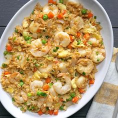 a white plate topped with rice and shrimp