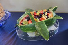 there is a fruit salad in the shape of a turtle on top of a watermelon