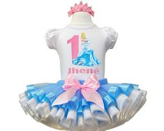 I offer you a beautiful birthday tutu outfit girls. NOTES FOR THE SELLER -Number for personalizing the top. -Name to personalize the vertex. -Need by date. Sleeve for the top - short, long. TOP. The top of it is 100% cotton. Size 3-24 months it is a bodysuit, 2T-10T it is a shirt. (Since it is more handmade always remember the shirt needs to be washed inside out, hand washed and air dried). SKIRT - made of soft tulle, edged at the bottom with a ribbon and decorated with a bow. Tutu is planted on Blue Princess Tutu Dress For First Birthday, Princess Style Blue Tutu Dress For First Birthday, White Princess Dress For Birthday, Blue Princess Dress For First Birthday, Princess Style White Tutu Dress For First Birthday, Princess Style Fitted Tutu Dress For Birthday, White Fitted Tutu Dress For Birthday, Birthday Tutu Outfit, Beautiful Birthday