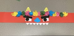 a paper mask with flowers on it and an animal's face in the middle