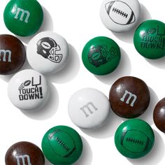 green and white footballs with m on them are arranged in a pattern, including the letter m