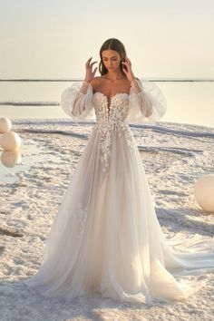 a woman in a wedding dress on the beach