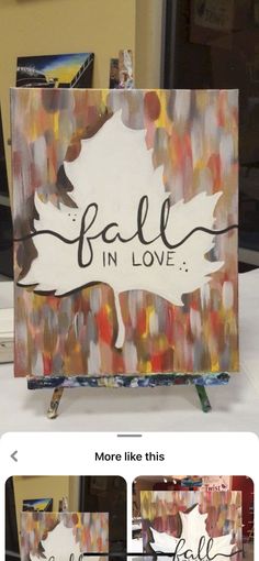 an easel with the words fall in love painted on it, along with pictures of autumn leaves and acrylic paint