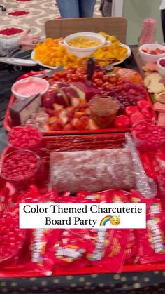 a table filled with lots of different types of food on plates and trays next to each other