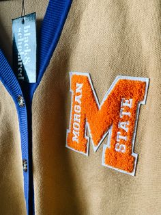 Make a bold statement and wear your Morgan State pride with this one-of-a-kind and comfortable cardigan sweater, perfect for any alumni, students or supporters. Made with the highest quality materials, this sweater is designed to keep you warm and cozy while representing Morgan State. Features:- Official Morgan State University logo embroidered on the chest- Large "M" Chenille patch- Classic cardigan design with a tortoise shell button-up front- Two front pockets (deep enough to fit a phone and