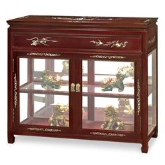 a wooden display case with glass doors and carvings on the front, two shelves holding figurines