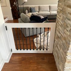 a living room filled with furniture next to a stair case