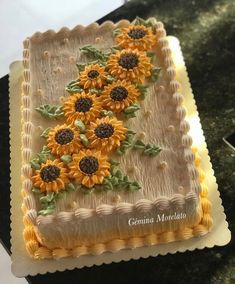 there is a cake with sunflowers on the frosting and icing decoration