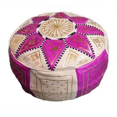 a pink and white round box with gold trimmings on the top, sitting in front of a white background