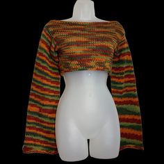 a white mannequin wearing a multicolored knitted crop top with bell sleeves