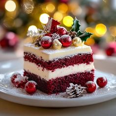 a slice of red velvet cake with white frosting and christmas decorations on the top