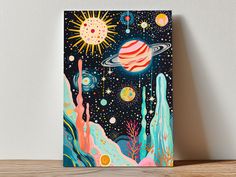 a card with an image of the planets and stars on it sitting on a table