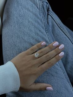 a woman's hand with a diamond ring on her left wrist, sitting in a car