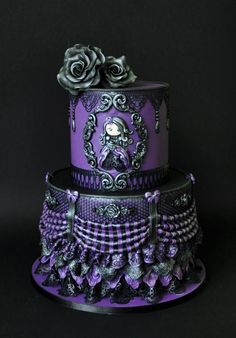 a three tiered cake with purple and black designs on it's sides, decorated with roses