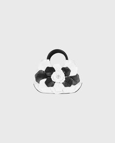 The SCARLET-MM is an updated version of the SCARLET-BB. This white bag features a black patent leather bottom and contrasting black and white textured petals. The SCARLET-MM is finished with two black circular handles and a zippered closure. The ideal size of this piece makes this bag the perfect accessory for any occasion. #html-body [data-pb-style="62FB5CA0A1DFA"]{justify-content: flex-start; display: flex; flex-direction: column; background-position: left top; background-size: cover; backgrou Lana Shirt, Black And White Handbag, Luxury Shirts, Black And White Bags, Floral Handbags, Spring Sneakers, White Handbag, Fall Coat, Pretty Bags