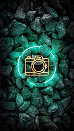 a camera is surrounded by green rocks and glowing neon lights in the dark, as if it were taken from above