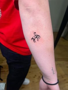 a person with a small tattoo on their arm