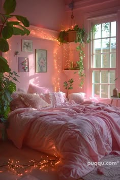 a bedroom with pink walls and lights on the wall, plants in window sill