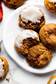 a white plate topped with cookies covered in frosting