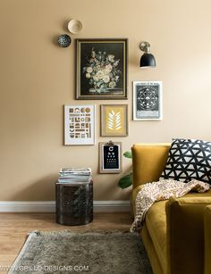 a living room filled with lots of pictures on the wall and furniture in front of it