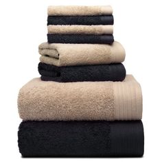 towels stacked on top of each other in black and beige colors, isolated against a white background