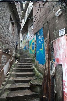 an alleyway with stairs and graffiti on the walls