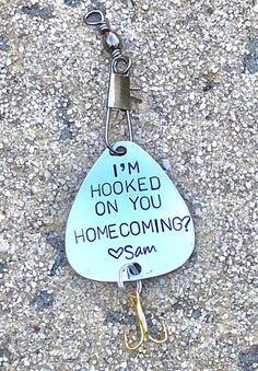 a keychain with a sign on it that says, i'm hooked on you home coming soon