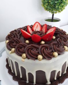 a cake with chocolate icing and strawberries on top