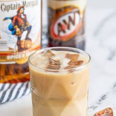 an iced drink with ice and nuts next to two bottles of captain morgan's