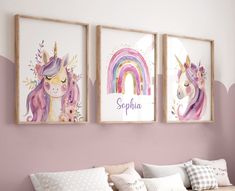 three unicorns are hanging on the wall above a bed in a girls'bedroom