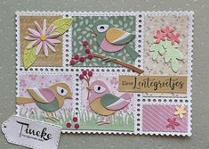 a close up of a stamp with birds on it and flowers in the back ground