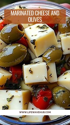 a bowl filled with olives, cheese and tomatoes